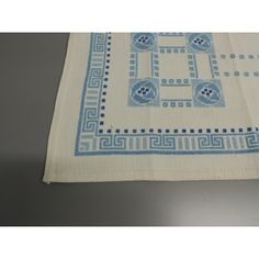 a white table cloth with blue designs on it