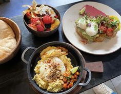 there are three different types of food on the table, including bread and salads