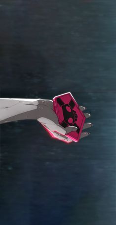 a person's hand holding a pink object in the air