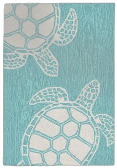 a blue rug with two sea turtles on the front and one turtle on the back