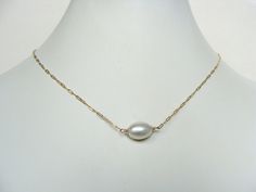 Pearl choker, short necklace, goldfill, gold pearl necklace, dainty, minimalist, adjustable 15-17 inches, handmade, Let Loose Jewelry Simple choker of one perfect pearl on a fine golden chain. This necklace is lovely alone or layered with your other pieces. The pearl is a luminous oval, 12x9mm, centered on a whisper-fine fancy-link chain...finished with a petite lobster clasp and an extension chain to give you a bit of wiggle room on fit: length is 15-17 inches. One little pearl drop decorates t Minimalist Pearl Chain Choker, Minimalist Pearl Charm Choker, Minimalist Gold Choker With Pearl Drop, Simple Choker, Wire Wrapped Chain, Phoenix Pendant, Golden Chain, Garnet Bracelet, Jewelry Simple