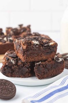 chocolate oreo brownies stacked on top of each other with one bite taken out