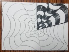 a drawing of a spider web on top of a piece of paper with black and white lines