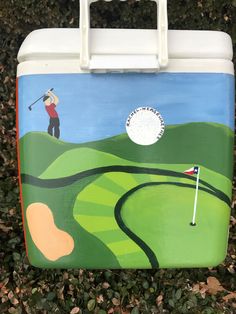 a cooler with a painting of a golf player on it