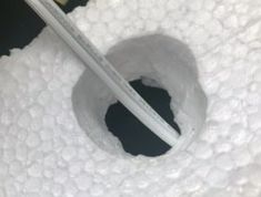 a toothbrush is sticking out of a hole in the toilet paper