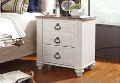 a white nightstand with two drawers and a mirror on top