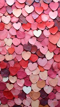 heart shaped confetti is displayed on the wall