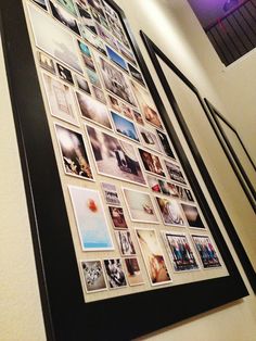 a black framed photo hanging on the side of a wall with multiple pictures attached to it