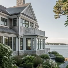 a large house sitting next to the ocean