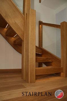 a wooden stair case in an empty room