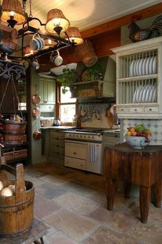 a kitchen with lots of pots and pans hanging from the ceiling over the stove