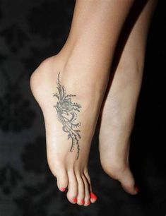 a woman's foot with a flower tattoo on it