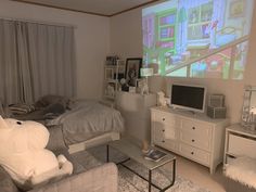 a living room with a bed, dresser and television