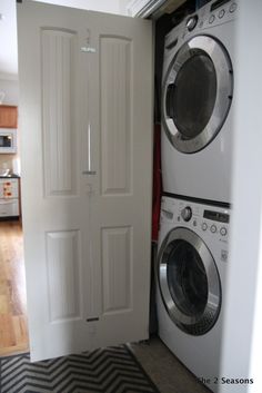 the washer and dryer are in front of the door to the laundry room