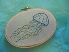 an embroidered jellyfish on a blue background