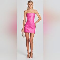 Think Pink With Our Vesta Leather Dress. This Bright, Bold Leather Mini Dress Was Designed To Stand Out In A Crowd. It Features An Oversaturated Hue, Dazzling Embellishments And A Strapless, Structured Bodice. Curved Seams And A Bodycon Fit Complete The Silhouette. Wear It With Our Castor Leather Jacket For The Full Effect. Shown Here In Neon Pink/Crystal. 100% Leather Think Pink, Leather Mini Dress, Leather Dress, Pink Crystal, Leather Mini, Neon Pink, Bodice, Embellishments, Colorful Dresses