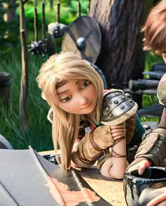 two dolls are sitting next to each other in front of a table with armor on it