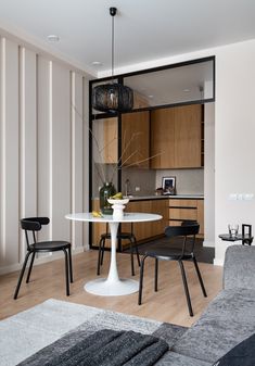 a living room filled with furniture and a white table