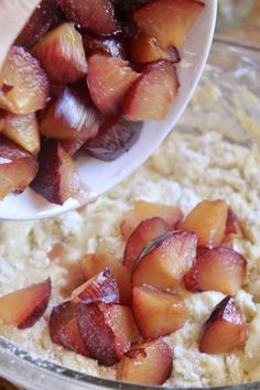 someone is scooping fruit into a bowl with oatmeal