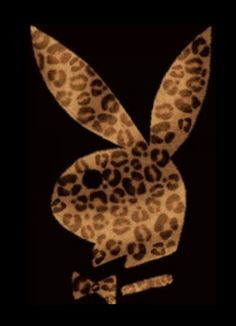 a rabbit made out of leopard print on a black background