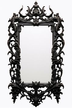 an ornate black mirror is shown against a white background