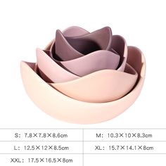 four bowls are stacked on top of each other in different sizes and colors, with the same size for each bowl