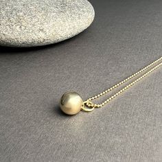 Made of solid 14k gold, our sphere charm symbolizes completeness and connection for those who wear it. It embodies the essence of our Golden Geometry collection, showcasing the beauty of form, the precision of mathematics, and the timeless allure of nature's perfect shapes. the Sphere pendant is available in solid 14k gold + sterling silver all charms come on a 14k gold ball chain necklace pendants are first hand carved in wax and then cast in either 14k gold or sterling silver perfect for every 14k Gold Necklace With Ball Chain, Yellow Gold Pendant Charm Necklace With Satellite Chain, Sterling Silver Pendant Necklace With Ball Chain, Yellow Gold Necklace With Satellite Chain, Elegant Ball Chain Jewelry, Minimalist Jewelry With Round Pendant Ball Chain, Gold Pendant Necklace With Ball Chain, Minimalist Yellow Gold Ball Chain Jewelry, Minimalist Jewelry With Ball Chain And Round Pendant