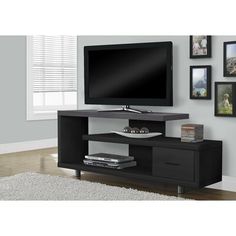 a flat screen tv sitting on top of a black entertainment center