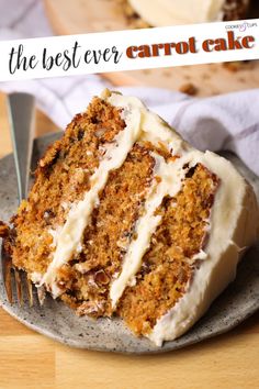 a slice of carrot cake with white frosting on a plate next to a fork