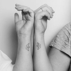 two people with matching tattoos on their arms