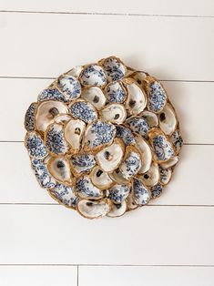 an arrangement of blue and white dishes on a white wooden table with wood planks