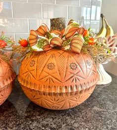 two decorative pumpkins sitting on top of a counter