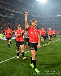 the rugby players are walking off the field after their team's victory over england