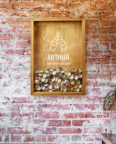 a brick wall with a sign that reads arthrur craft beer collection on it