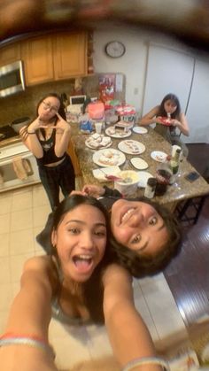 three young women are taking a selfie in the kitchen with plates on the counter