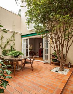 an outdoor dining area with table and chairs