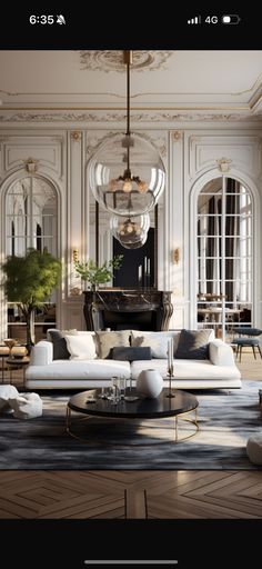 an elegant living room with white furniture and chandelier hanging from the ceiling in front of a grand piano