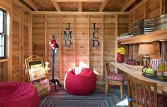 a room filled with lots of furniture and wooden walls