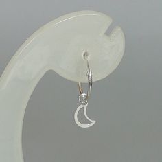 A PAIR of sterling silver hoops. Comes with a detachable cut out crescent moon charm. The charm is multipurpose and can be used with a neck or bracelet chain too. Dimension: Hoop- 15 x 1.5 mm Charm: 6 x 12 mm Drop length- 23 mm These earrings are made of 925 hypoallergenic sterling silver and plastic. Please note this price is for ONE PAIR. All my pieces are sent in a gift box. I can include a personal message from you if needed You are welcome to contact me at... bhavnakwintra1956@gmail.com For Evil Eye Earrings, Thread Earrings, Moon Charm, Threader Earrings, Bohemian Earrings, Sterling Silver Hoops, Star Charms, Silver Hoops, Gorgeous Earrings