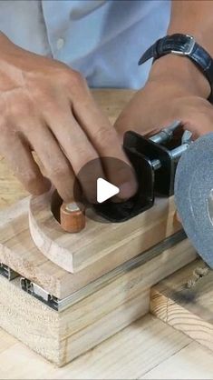 a person using a circular saw to cut wood