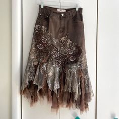 Rossi Roma Brown Denim Layered Ruffle Sequin Midi Skirt. Embroidered Flowers And Paisleys With Sequin Detailing. Raw Hem Lace Ruffle. Some Wear To The Lace/ Ruffle Bottom But Otherwise And Great Condition. Size Small **Matching Denim Top Available** Material: 76% Cotton, 14% Nylon, 10% Elastane Waist: 27 Inches Approx Length: 30.75 Inches Approx Tags Y2k Vintage Rare Coquettegirl Romantic 90s Maximalism Lace Layered Skirt Edgy Fall Autumn Jean Skirt Free People Like Anthropologie Like Urban Outf Jean Skirt With Lace, 90s Maximalism, Tattered Skirt, Patch Skirt, Sequin Maxi Skirt, Dolly Christmas, Maxi Sequin Skirt, Unique Skirt, Sequin Midi Skirt