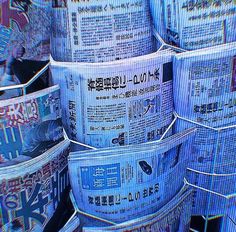 several stacks of newspapers stacked on top of each other