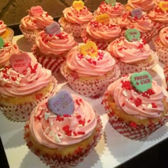 many cupcakes with pink frosting and hearts on them