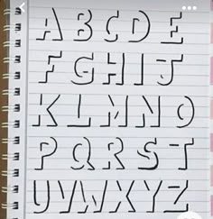 an open notebook with the letters and numbers drawn on it