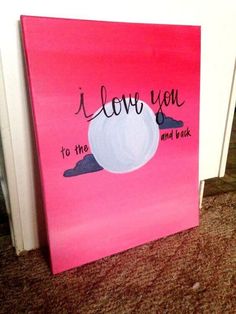 i love you to the moon and back painted on pink canvas with white frame sitting on carpeted floor