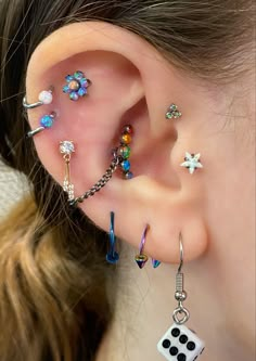 a close up of a person's ear with some piercings on it,