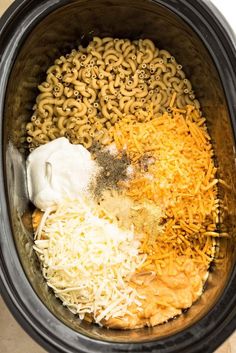 an image of food in the crock pot with cheese and other foods inside it