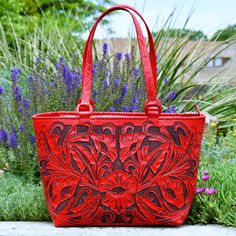 A timeless piece to add to your collection! This gorgeous and unique statement bag is all tooled leather and all yours! Red floral tooled front and basket weave tooled back are accentuated with a black patina. Embossed handles attached with leather covered D-rings for durability, and lacing along the seams. Top zipper closure. Suede lined inside, with two open pouch pockets and a zipper pocket. Red Hand Tooled Rectangular Bag, Red Hand Tooled Shoulder Bag For Daily Use, Hand Tooled Red Rectangular Bag, Red Hand-tooled Rectangular Bag, Red Hand Tooled Bag For Daily Use, Radiant Red, Western Look, Statement Bag, D Rings