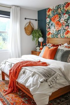 a large bed sitting next to a window in a room with floral wallpaper on the walls