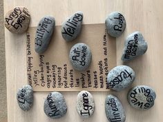 some rocks with writing on them sitting on top of a piece of paper